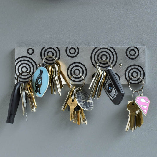 Magnetic Key Holder in brushed aluminum and black with circles.